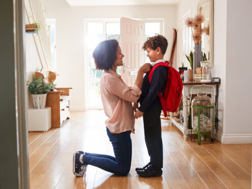 mother getting child ready for school